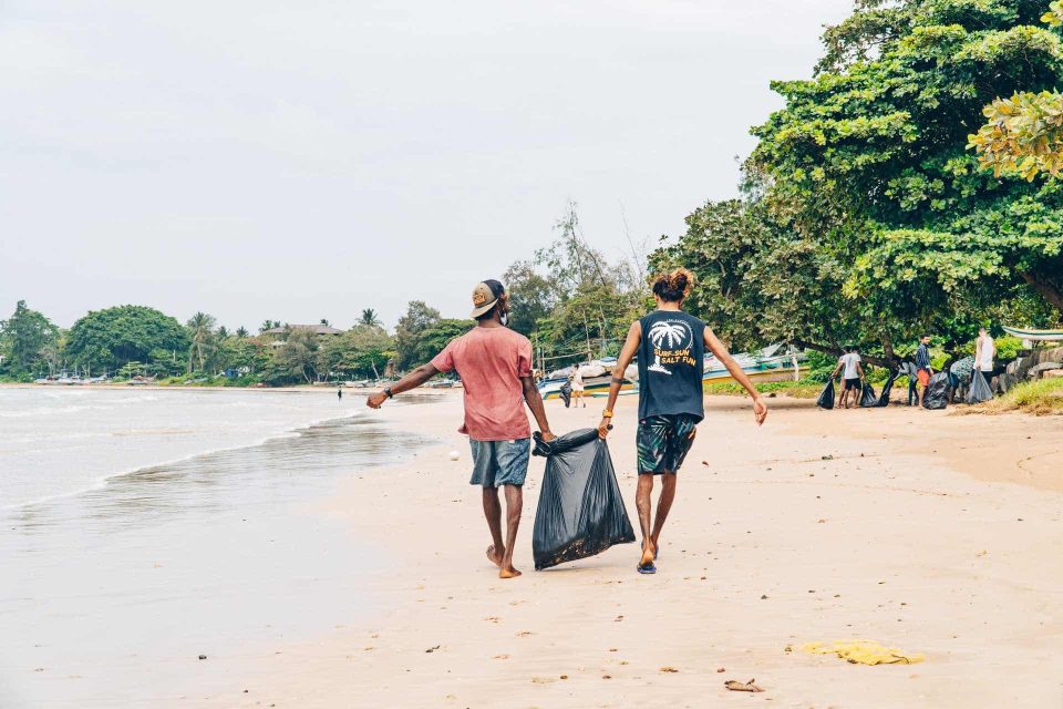 Surfers cleaning up beach