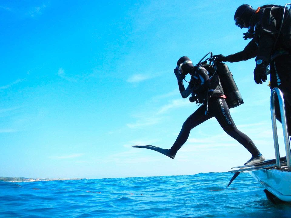 Scuba diver jumping off of boat