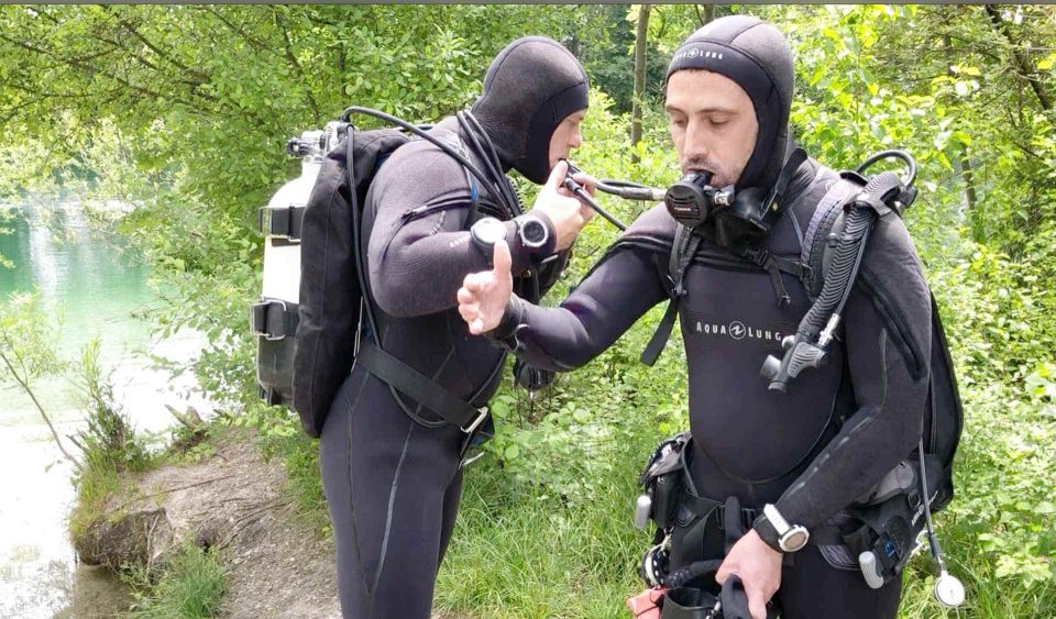 Two divers doing buddy check at Social Diving