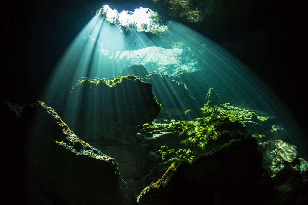 Cavern lit by sunlight through hole