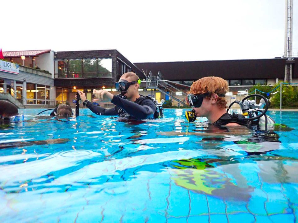 Children scuba diving course in pool