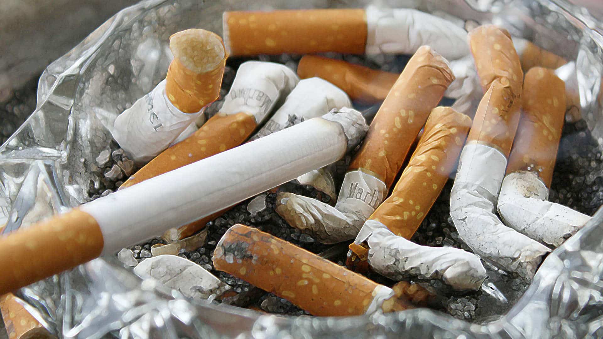 Cigarettes in glass ashtray