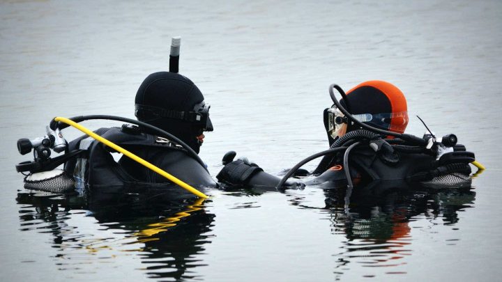 Dive Control Management 8 Scuba diving instructor in the water with student.