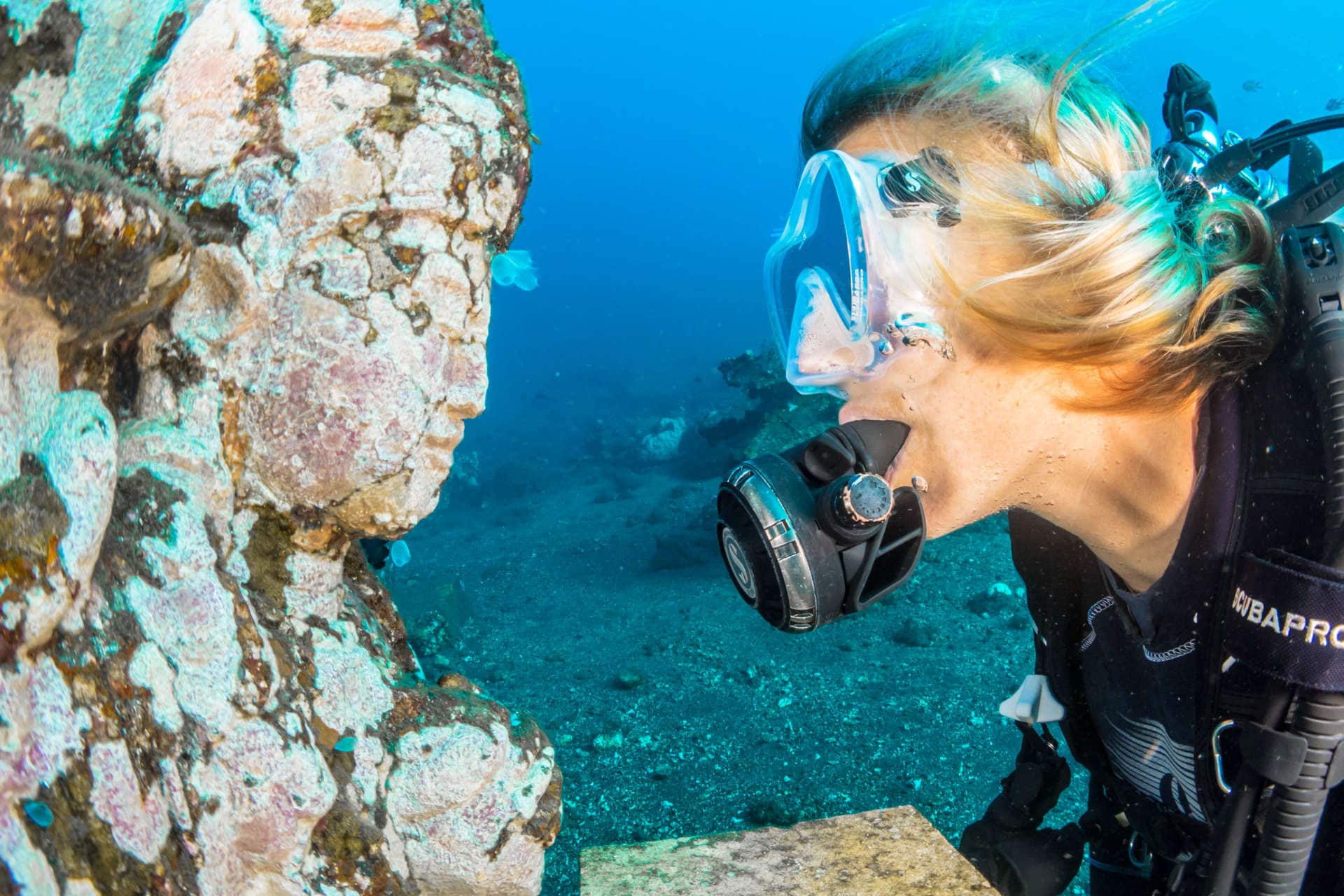 Female diver looking at rock