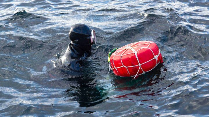 Female rescue diver at surface