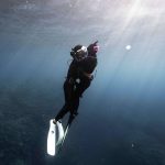 Freediver couple kissing underwater