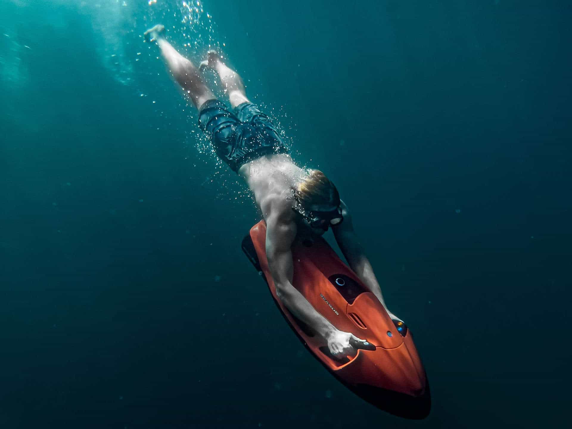 Freediver with underwater scooter