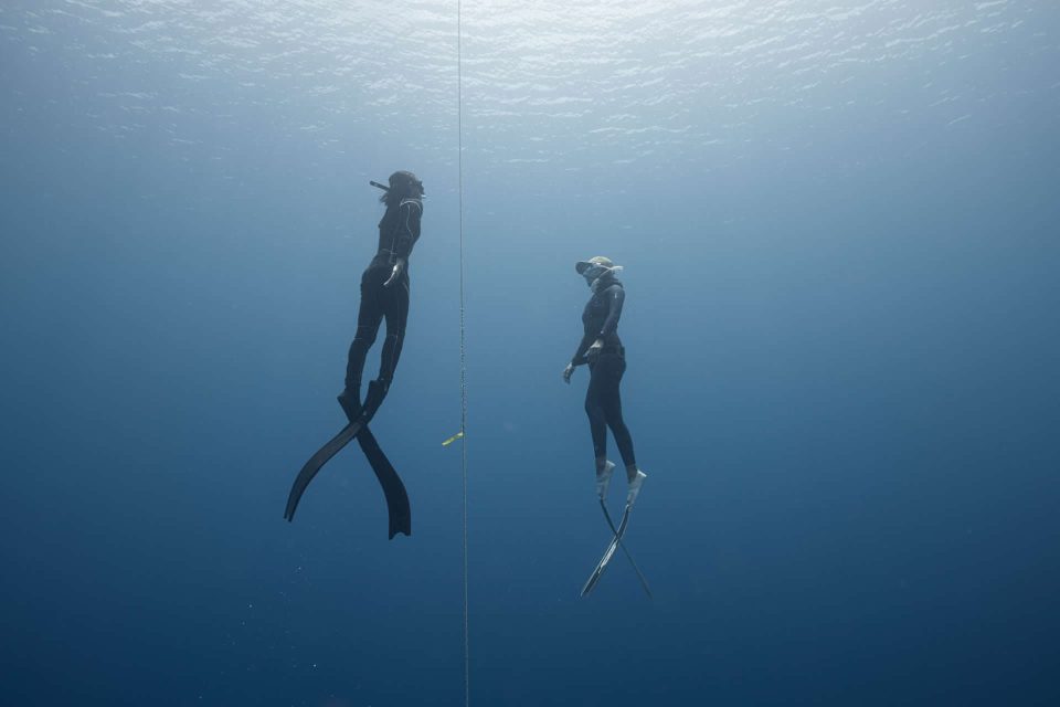 Freedivers ascending on line underwater