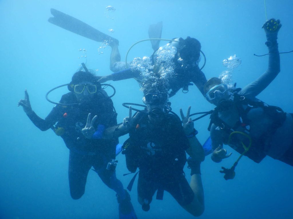Happy scuba divers underwater