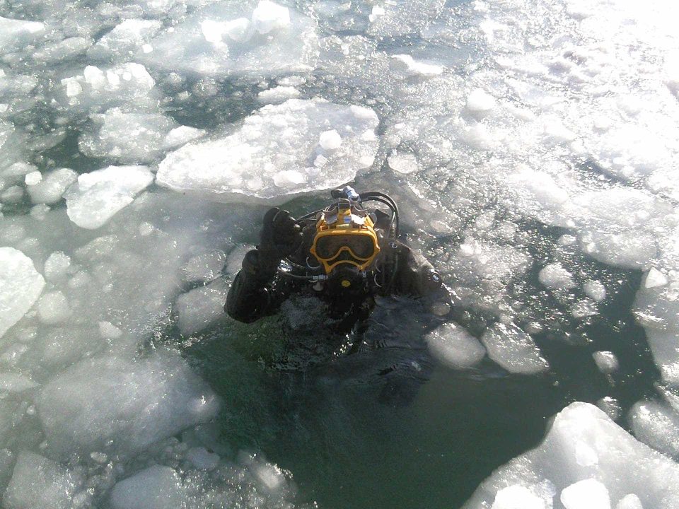 Helmet diver under ice