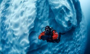 Kallweit drysuit diver underwater with iceberg