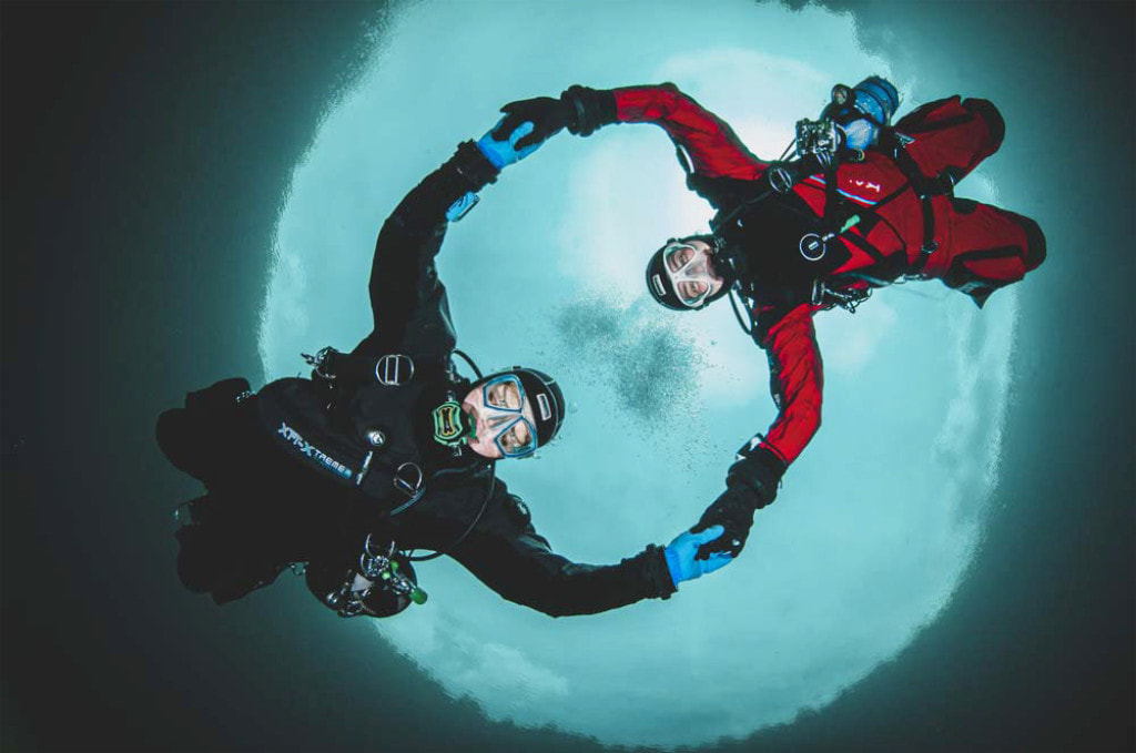 Two scuba divers holding underwater