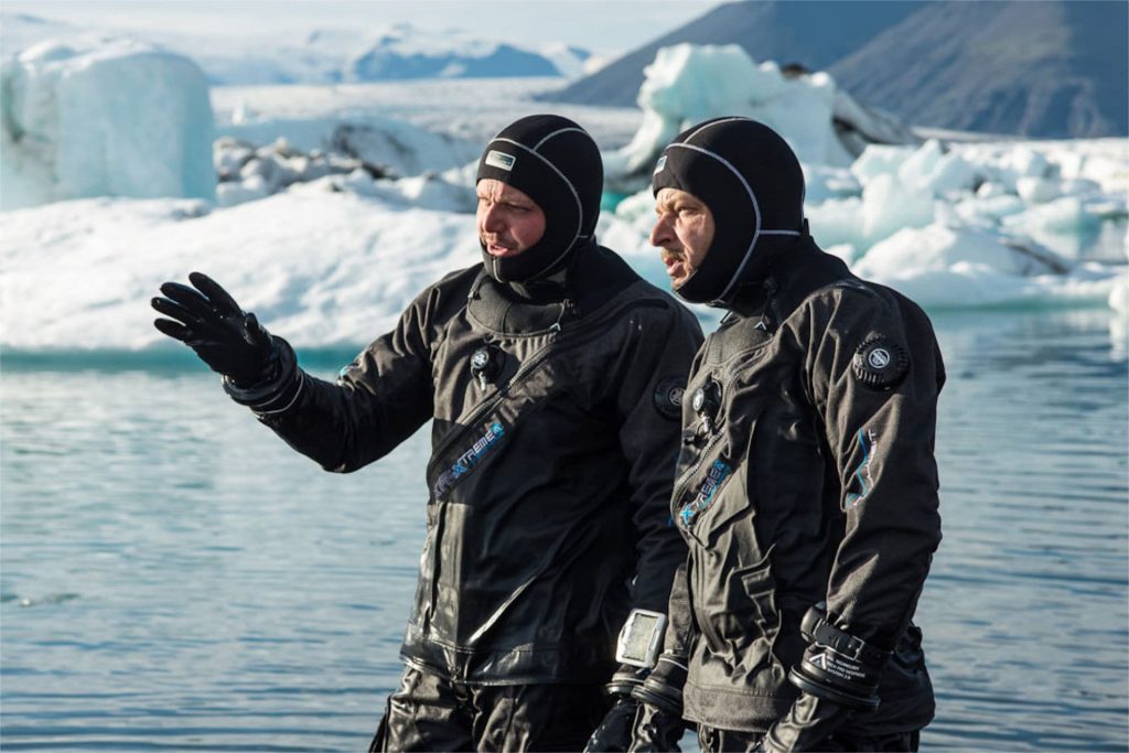 Two divers in drysuits