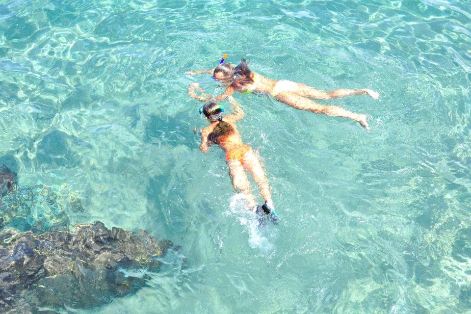 2 kids snorkeling at water surface