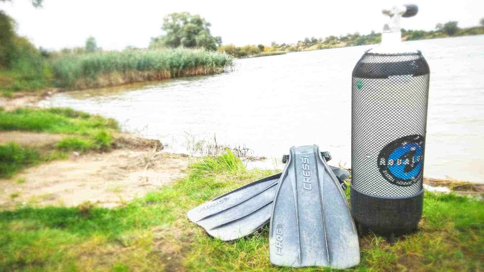 Scuba tank and fins at shore