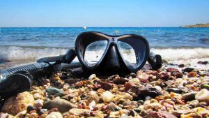 Mask and snorkel laying on beach