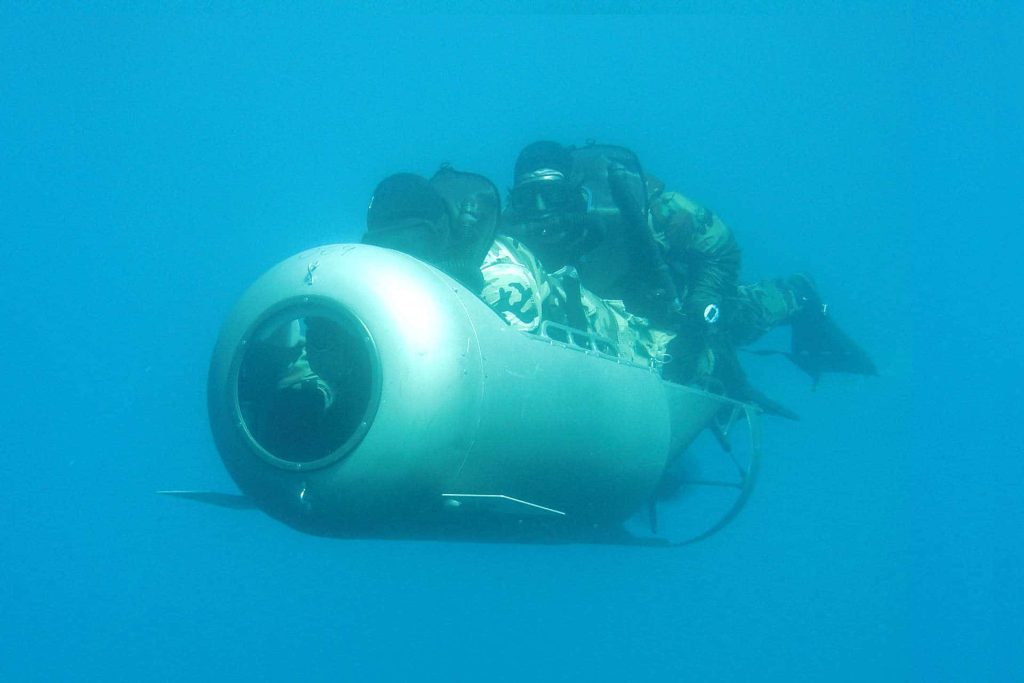 Military divers using diver propulsion vehicle