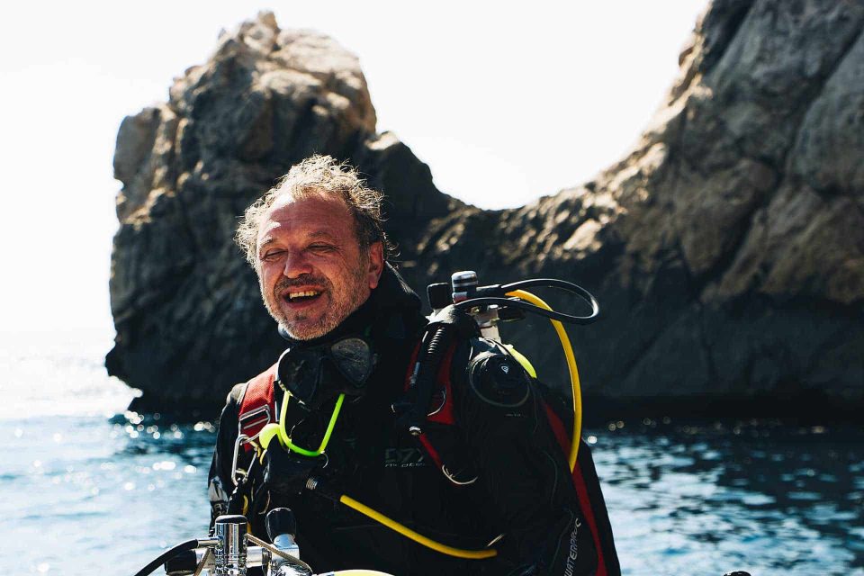 Old diver smiling on boat before dive