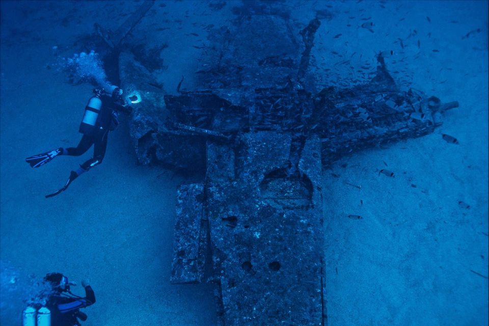 Divers exploring underwater plane wreck