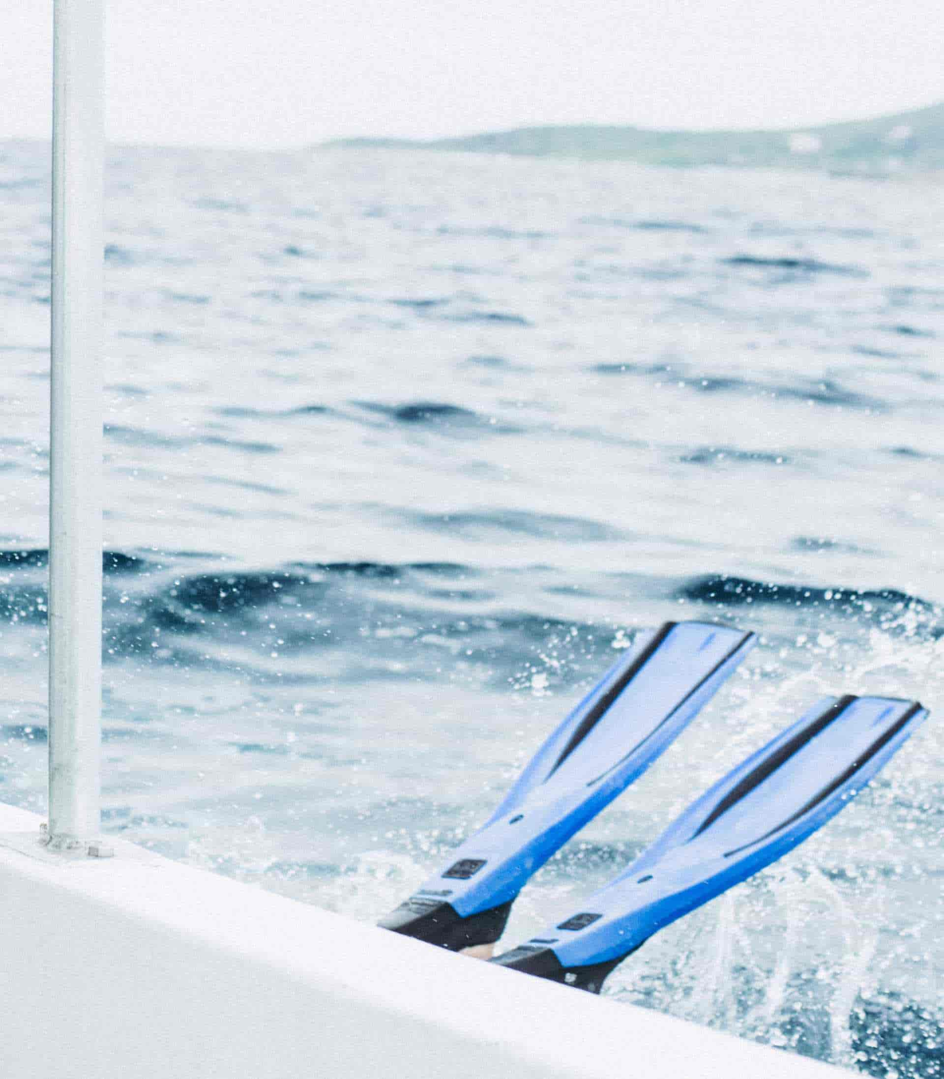 Scuba diver rolling backward off of boat