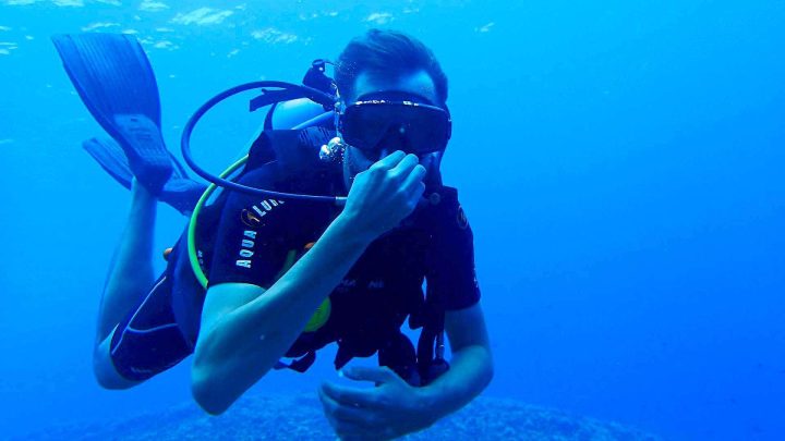 Scuba diver equalizing underwater
