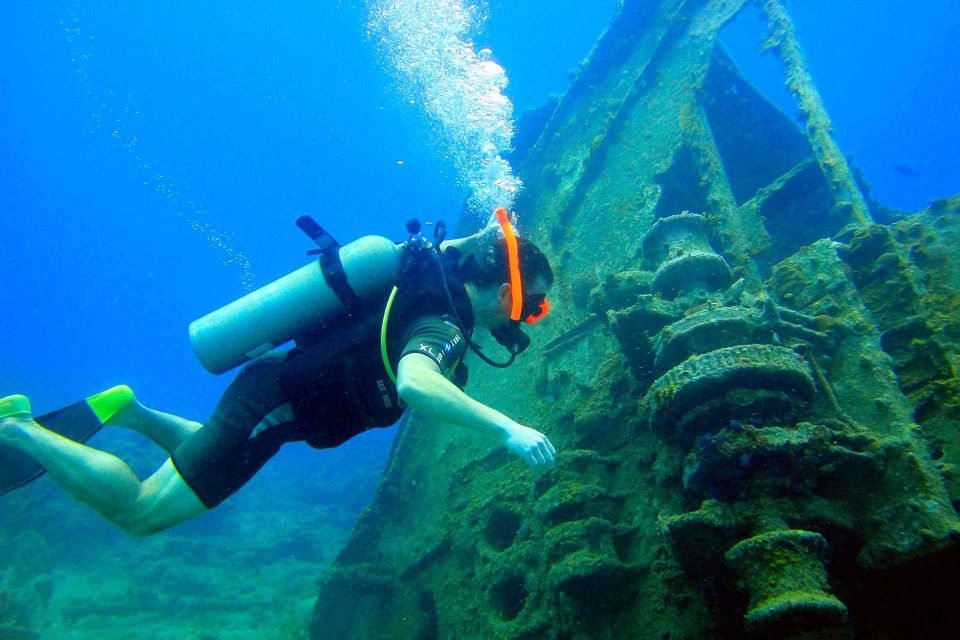 Scuba diver with orange snorkel at wreck