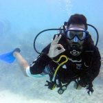 Scuba diver showing okay signal underwater