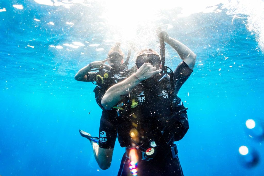 Scuba divers equalizing ears while descending