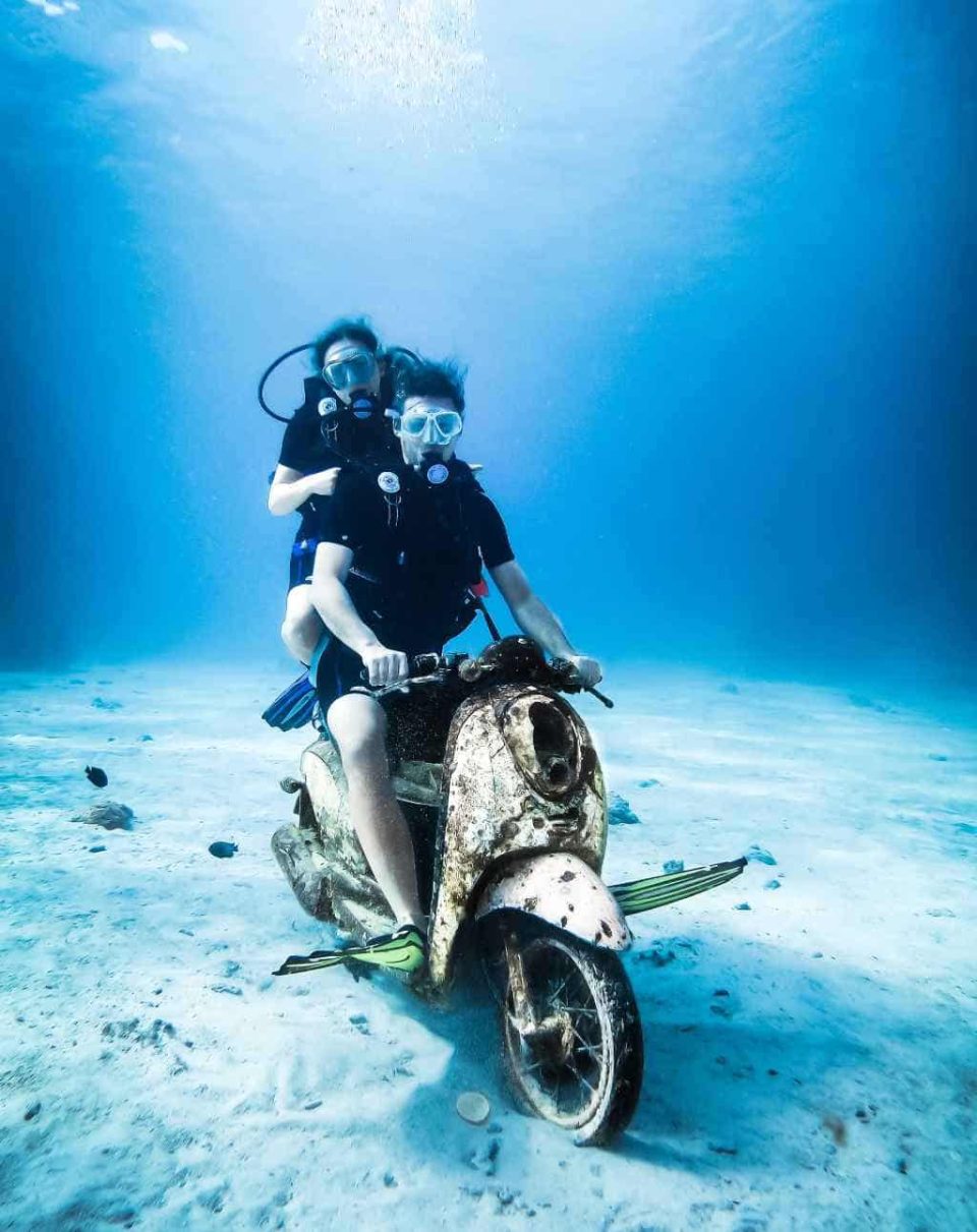 Scuba divers underwater on vespa