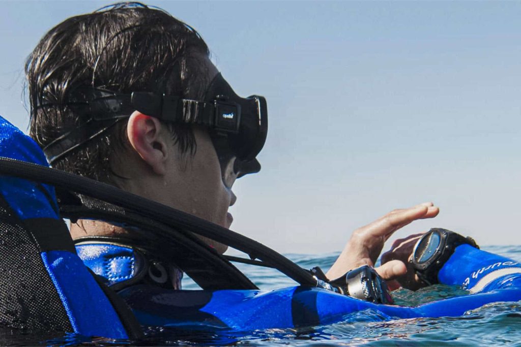 Diver checking Shearwater Teric dive computer at surface