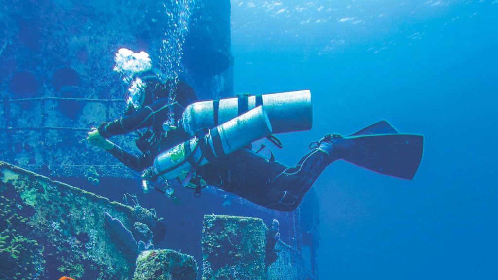 Sidemount diver at wreck