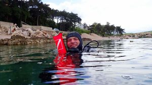 Scuba instructor with surface marker buoy