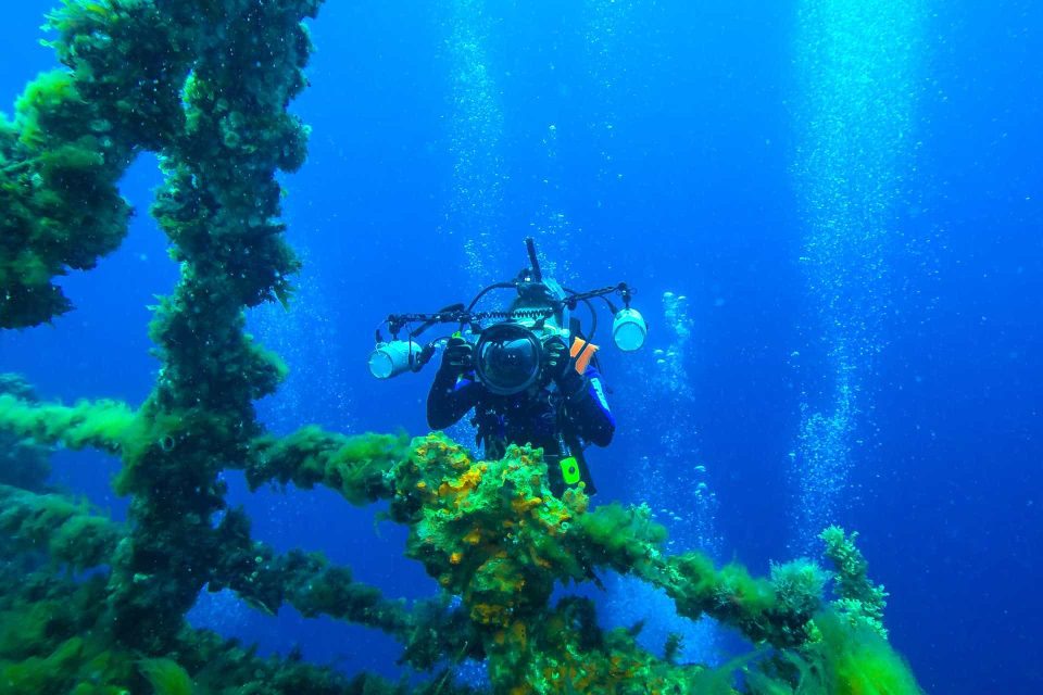 Scuba diver photographing wreck